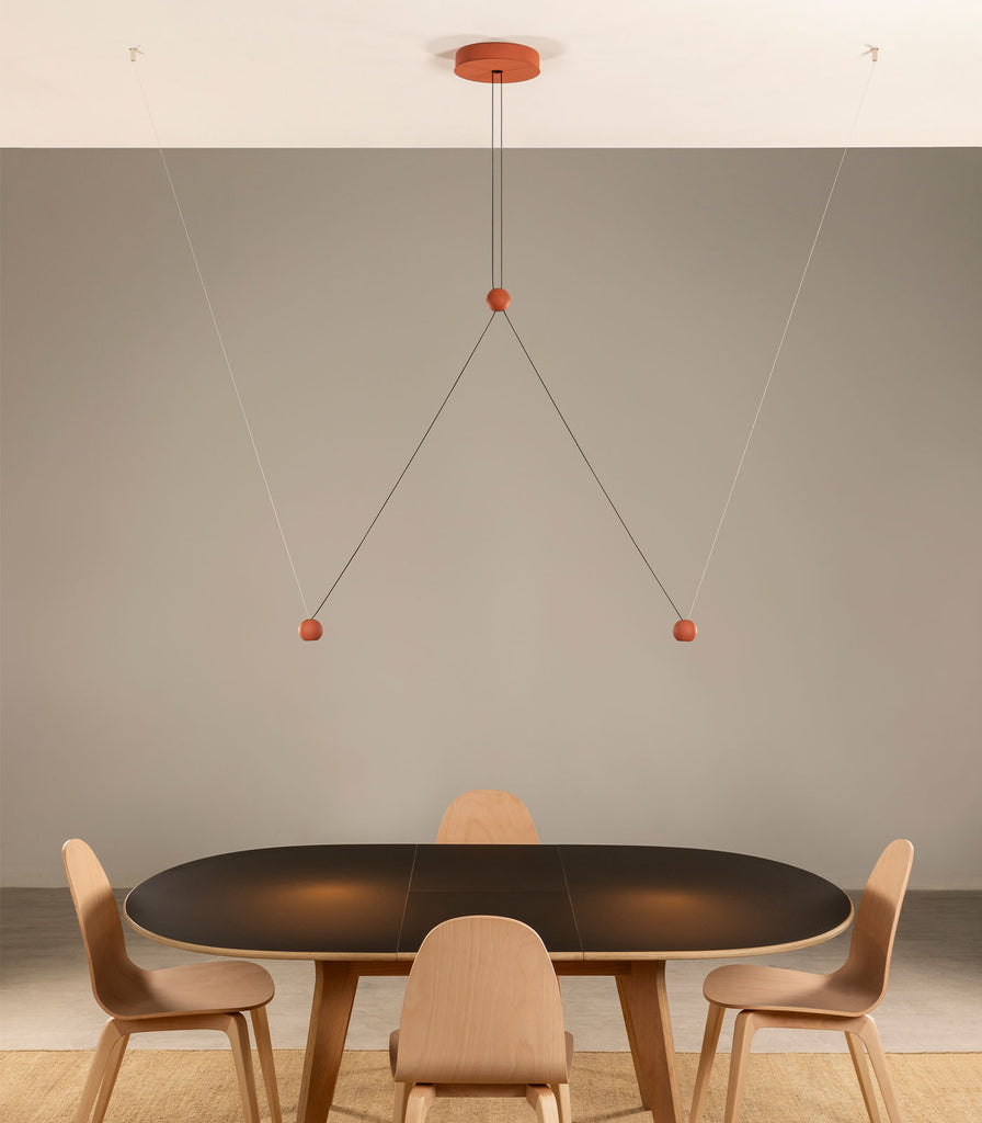Lighterior Compass Cluster Pendant Light hanging over dining table