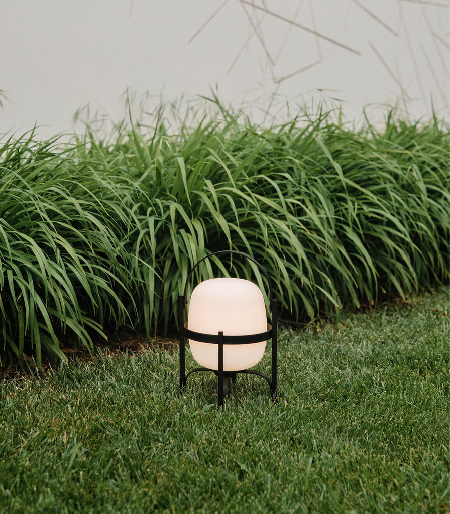 Santa & Cole Cestita Alubat Portable Table Lamp featured within outdoor space