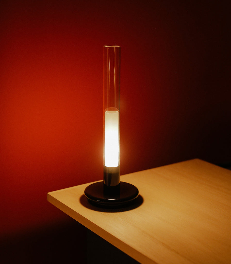 Santa & Cole Sylvestrina Portable Table Lamp featured within interior space