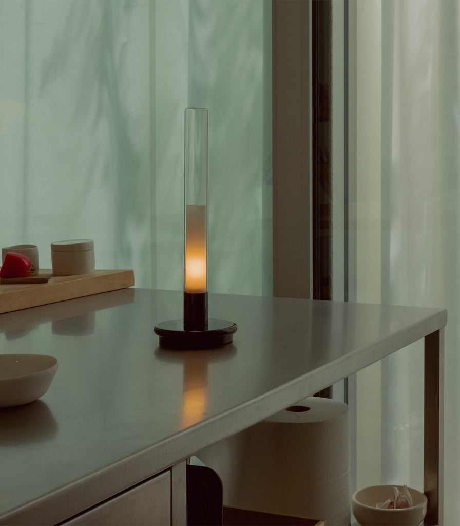 Santa & Cole Sylvestrina Portable Table Lamp featured within interior space