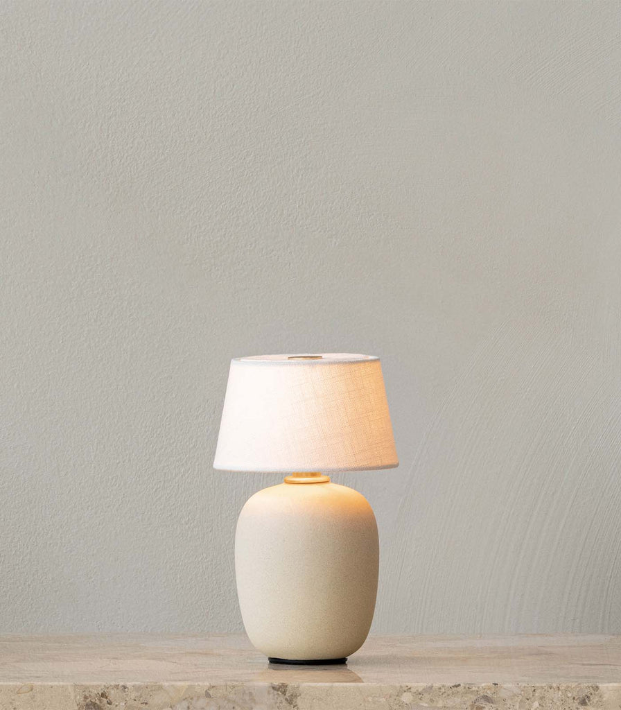 Menu Lighting Torso Portable Table Lamp featured within interior space