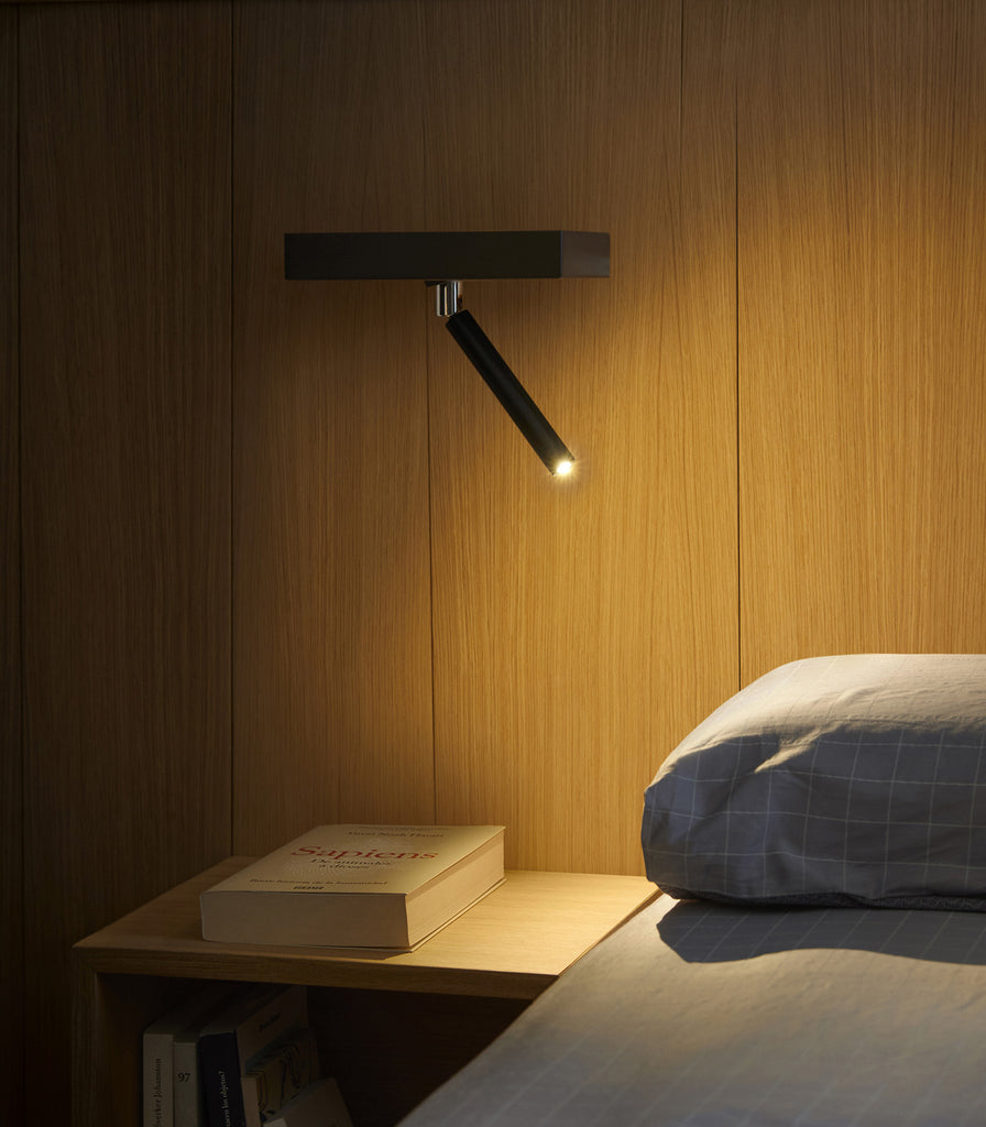 Estiluz Nit Wall Light hanging over bedside table