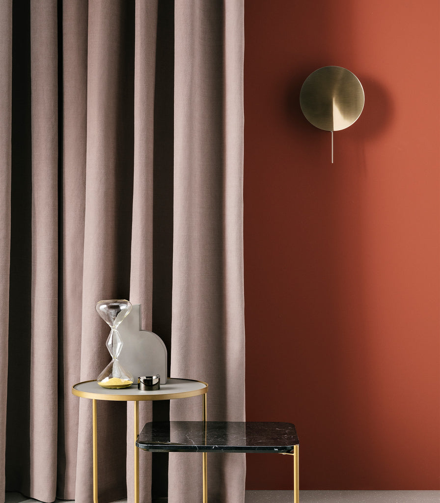 Estiluz Obs Wall Light in Satin Gold featured within interior space